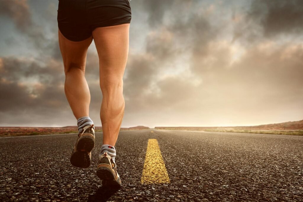 pexels-photo-421160-421160 Runner's legs on a road during a sunset, symbolizing endurance and outdoor fitness training.